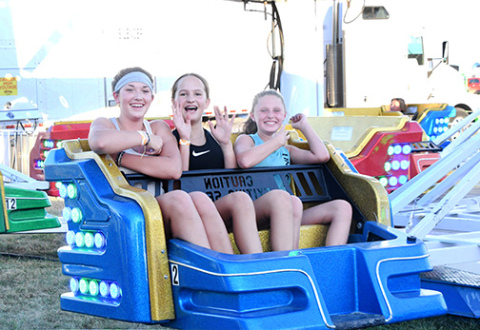 Pictured from left, Khloe Allen, Josie Daugherty and Shelly Staehr smile from the spinning thrills on the midway. 