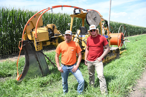Noah Tripp, left, and Jared Snyder stand near drilling equipment as partners in their new Quality Underground LLC business.