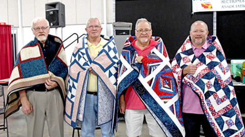 From left to right, veterans Gil Nissen, Jim Pfeifer, Jerry Chadwick and Troy Chadwick stand tall with their quilts.