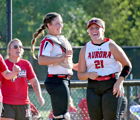 Aurora’s Kaelin Sparr (left) and Sydney Thomas celebrate after the softball team’s 15-0 win over Lexington Thursday. 