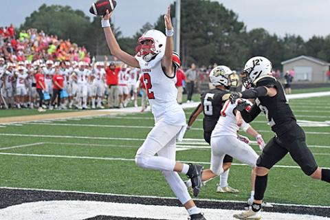 Booker Scheierman throws his hands up after one of his seven total touchdowns in Aurora’s 50-30 win over Grand Island Northwest Friday. 