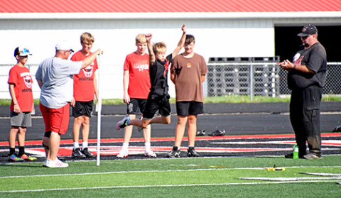 An Aurora middle schooler catches some air on Thursday at the opening of football practice.