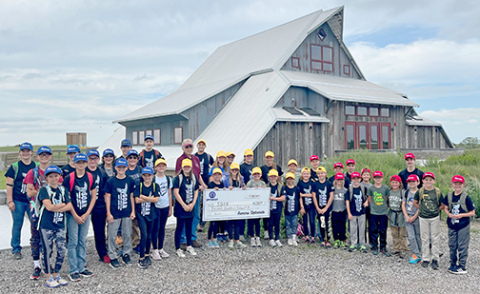 Optimist Club of Aurora presents a donation check to the campers at Summer Orientation About Rivers (SOAR).