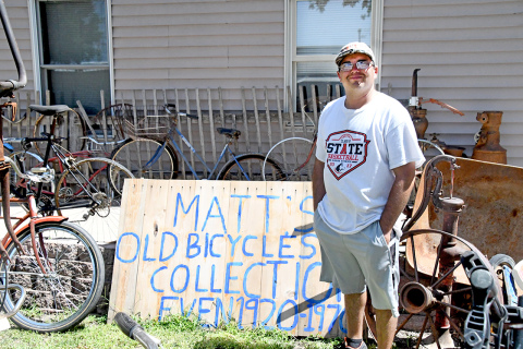 Matt Sisson stands proudly among his collected bikes that he wishes to show to the community.
