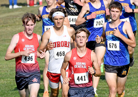 Jalen Daugherty makes a break through the pack of runners near the halfway point of the boys cross country race at the Aurora Invite on Friday.