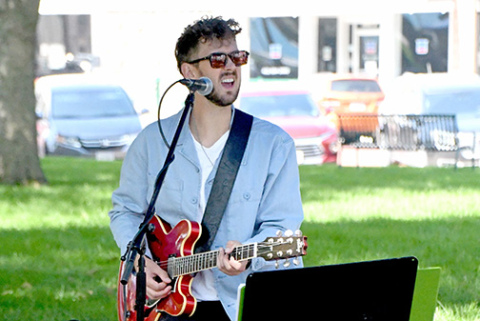 Musical artist Myles Jasnowski performs outside the courthouse during Art Walk Aurora Sunday afternoon.
