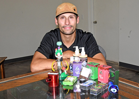 Jordan Oliva-Harring displays some of the cannabinoid inventory now available at High Vibe Spiritual Wellness on 9th Street in Aurora.