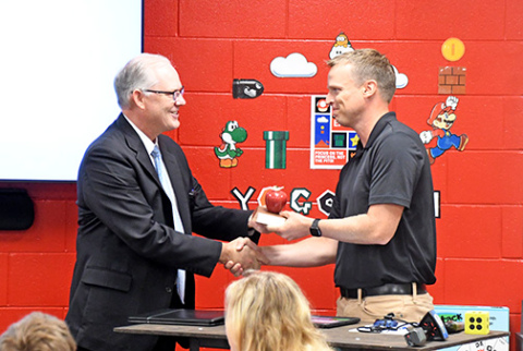 Nebraska Commissioner of Education, Brian Maher, left, presents Aurora Middle School teacher Scott Phillips with the 2024 Nebraska Teacher of the Year award on Wednesday morning. 