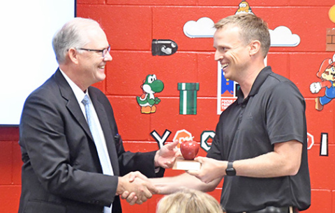 Nebraska Commissioner of Education, Brian Maher, left, presents Aurora Middle School math teacher Scott Phillips with a plaque recognizing him as 2024 Nebraska Teacher of the Year. 