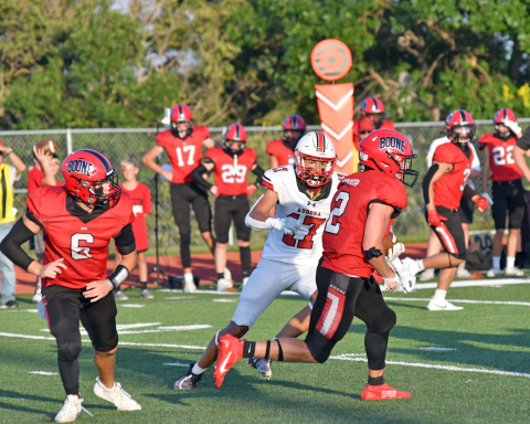 Tyson Dvorak squares up Boone Central's Parker Borer in the backfield during Aurora's 42-7 loss to the Cardinals. 