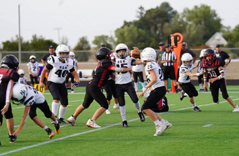 H&H players are shown in action here during the 8-man league championship game Oct. 1, which the Coyotes won 28-18.