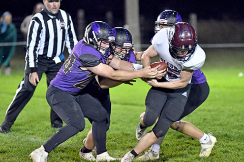 Hampton’s defense rips at the football during one of St. Edward’s fourth quarter possessions as the Hawks held on for a 48-40 win. 