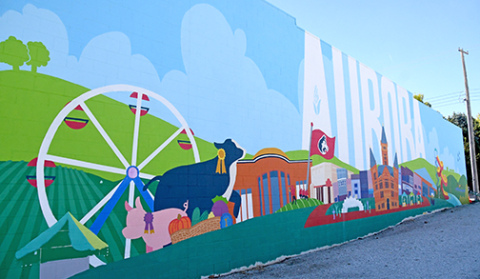 The Aurora mural being painted on the side of the Hamilton Communications building. 