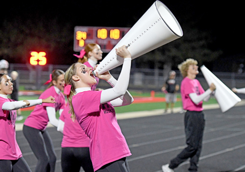 Camdyn Vermillion shouts a cheer to the crowd through the megaphone.
