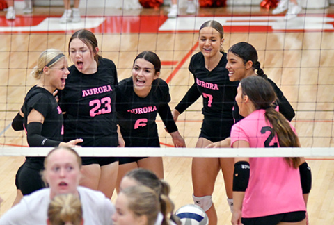 Aurora celebrates after a point during its three-set win over Lexington Sept. 26. The Huskies are set for its regular season home finale Thursday against Hastings. 