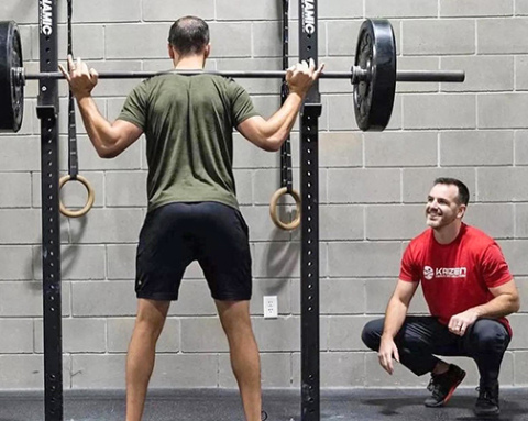 Bryan Ladd, right, watches as a patient works out in the weight room. 