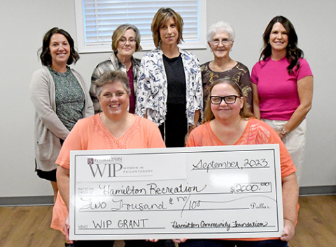 Pictured in front representing Hamilton Recreation Inc., are from left: Kathy Dyer and Tina Collingham. Women in Philanthropy members presenting the check include, back from left: Laura Reeson, Melanie Klute, Jill DeMers, Myra Higgins and Jaime Kreutz.