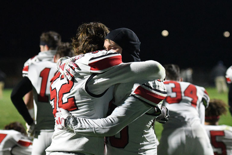 Collin Stolpe and Maddex Egger share an emotional post-game hug.
