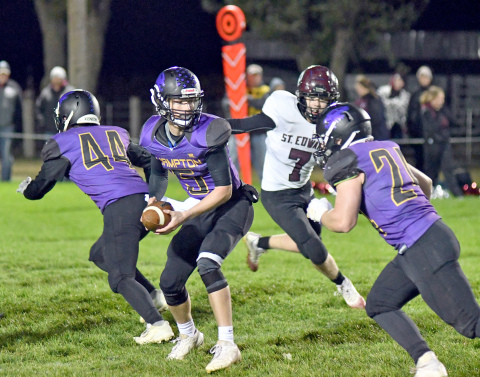 Brayden Dose turns around for the handoff during Hampton's 48-40 win over St Edward Friday.