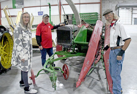 Pictured from left, Donelle Moormeier, Scotty Andreasen and Howard Raymond, all members of the International Harvester Collectors organization, inspect an antique combine at the Plainsman Museum as part of their Saturday meeting in Aurora.