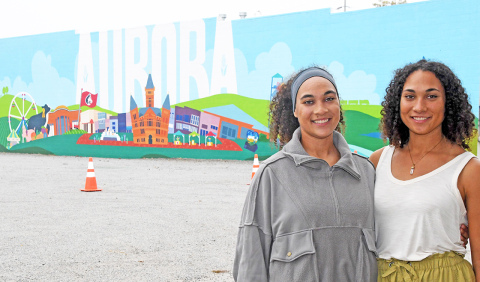 Mural artists Bristol, left, and Brianna Lewis pose for a photo in front of their finished artwork.