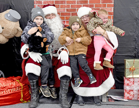 From left, Dustin Wall, Declan and Brynlee Casto were among the few kids who were a little nervous meeting Santa for the first time.