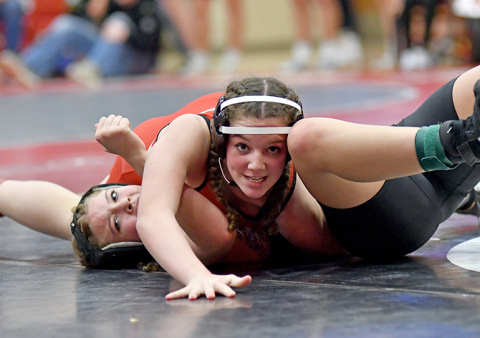 Di Maria Leininger looks for the camera while collecting a pinfall victory during Aurora’s home Invite Thursday. The Husky girls won the team title, edging Grand Island Northwest by 15 points. 