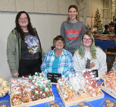 Sandy’s Cookies, Macs & More offered a variety of treats at the Holiday Shopping Spectacular at the Hamilton County Fairgrounds on Nov. 4. Overseeing the operation is Sandy Sebesta, seated center, along with granddaughters, from left, Autumn Paquin, Nadine Lovejoy and Brooklyn Paquin.