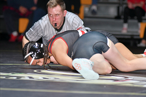 Aubrie Beed rolls over for the pinfall victory during Aurora’s dual against Grand Island Northwest last week. The Aurora junior has gone through the first month of the season with an undefeated mark. 