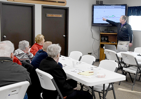 Dale Broekmeier, right, points to a plant flow diagram of the new CVA white corn cleaning plant currently under construction in Hampton. The presentation was part of the program at last Tuesday’s second Community Conversations with Coffee event sponsored by Hampton Public Schools and held at the Fire Barn. 