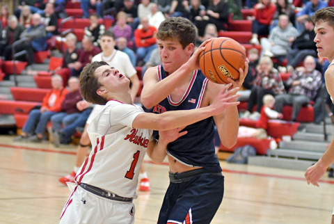 Canon Allen tries to poke the ball away to save an extra offensive possession during Aurora’s 44-42 loss to Adams Central Thursday. 