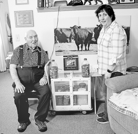 East Park Villa resident Ramer Fassnacht and his daughter, Teresa Smith, display some of the jugs of pennies they have collected in anticipation of Fassnacht’s 100th birthday next March. The father and daughter are on a mission to collect one penny for every day of Fassnacht’s life. 