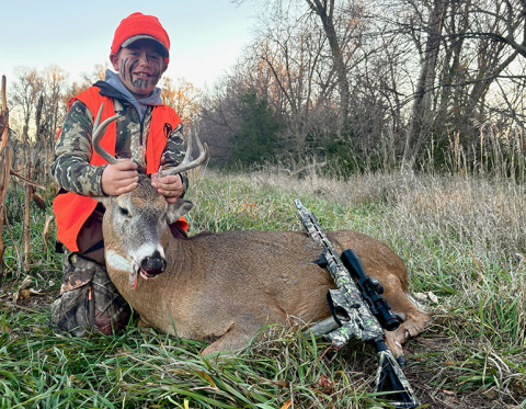 Jackston Griess proudly displays his first-ever deer, which he shot near Roseland with his father, Luke, on opening day.