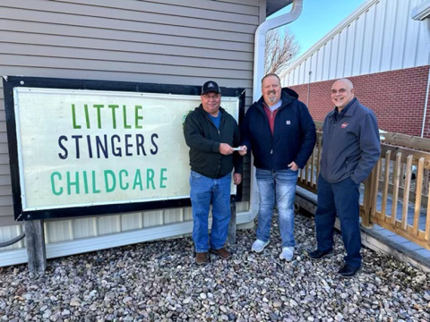 Control of Little Stingers Daycare in Giltner was transferred from the Giltner Area Development Corporation (GADC) to the Giltner School Foundation on Wednesday, Nov. 1. GADC president Gary Consbruck, left, presents a document transferring operation of the daycare to foundation member Joel Hinrichs. At right is GADC treasurer Eric Leichty. 