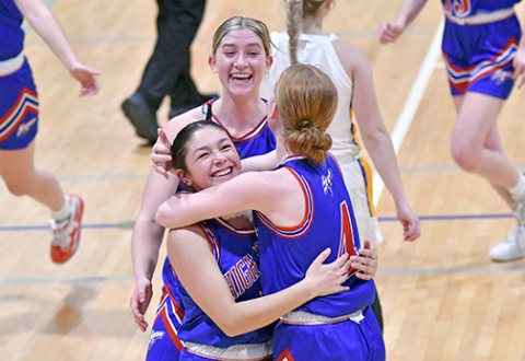 HPC’s girls basketball team took time to celebrate a 32-30 come-from-behind victory over Shelby-Rising City in the CRC quarterfinals Monday. Coach Megan Bruce comes to join the group hug started by Courtney Carlstrom (left), Gahvi Lesiak (middle) and Peyton Hofmann. 