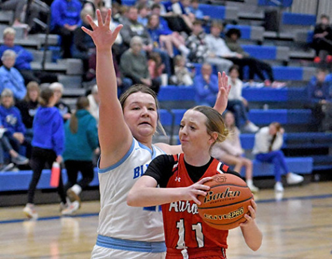 Aurora junior Adi Fahrnbruch drives the lane against Ashland-Greenwood’s Reaghan Craven. Fanrnbruch hit a buzzer-beater at the end of regulation to help the Lady Huskies advance.
