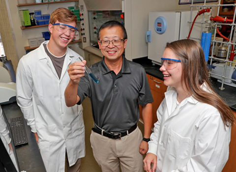 Aurora native Trevor Dvorak, left, works with Dr. Haishi Cao and fellow student Madeline Riesberg in a UNK chemistry lab. Dvorak is one of several area students sharing how the COVID pandemic impacted his educational experience.