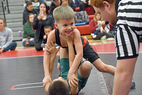 Jack Rath eyes down a potential pinfall victory while giving a look to former Husky turned official Brekyn Papineau. 