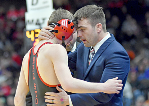 Aurora senior Lance Russell receives a motivational message from his coach, Martin Phillips after suffering a shoulder injury early in his finals match and had injury time run out on his chances. 