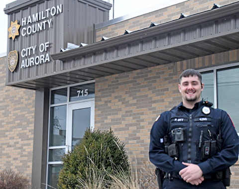 The City of Aurora’s newest police officer, Peyton Ott stands in front of the Aurora Law Enforcement Center Friday. Ott was sworn in at the Jan. 9 city council meeting and is a a native of Henderson. 