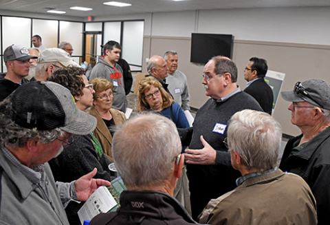John Hewitt, Synergen Green Energy's vice president and head of projects, visits with local residents during a Q&A meeting regarding the company's proposal to build an ammonia plant west of Aurora. 