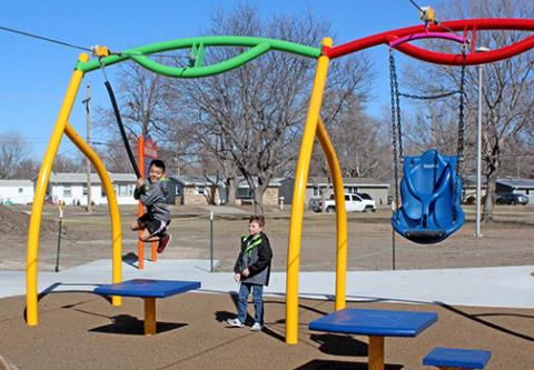 Side by side ziplines at the Pirnie inclusive playground in Grand Island feature the traditional disc on the left for able-bodied kids to straddle, while the zipline on the left features a swing seat to hold children with disabilities. 