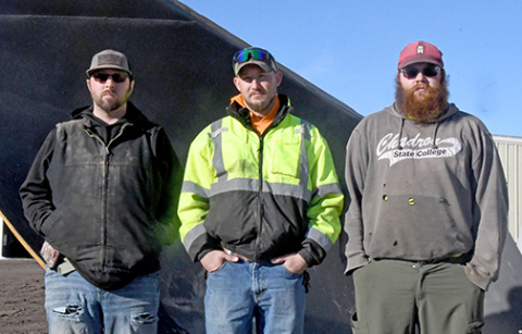 Three employees of the Hamilton County Highway Department stand in front of one of the huge v-plows that were used to open 960 miles of gravel county roads during last month’s storms. From left are Beau Johnson, Asst. Supt. B.J. Frauendorfer and Dylan Christenson.  