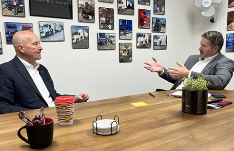 U.S. Sen. Pete Ricketts visits with IWS owner Todd Vettel on Monday. 