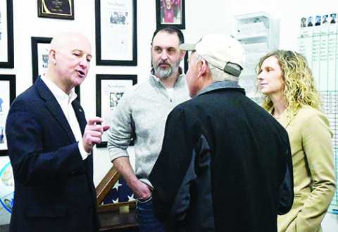 U.S. Sen. Pete Ricketts talks with local residents during his “Meet with Pete” visit to Aurora on Monday. Pictured from left are Mike Bergen, Francis McDonald and Kelsey Bergen.