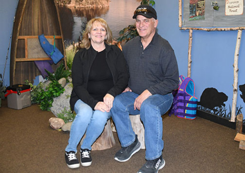 Dan and Linda Huenefeld pose for a final photo in the Boundary Waters escape room game, which featured puzzles all created personally by the owners.
