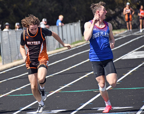 HPC’s Gavin Morris looks to his left to see his winning 100 meter dash time, finishing just ahead of Giltner’s Blaydon White (left). 