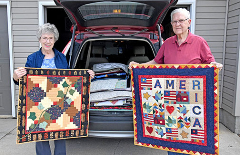 Lorna and Larry Epp show two of the 80 quilts that they recently delivered to a museum in Hamilton, Mo. The Aurora woman is the co-founder of the Nimble Thimble Quilt Guild and has created more than 400 quilts in her lifetime.