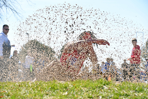 Vendell Juyzk is somewhere behind this large spray of sand during one of his long jump attempts at Thursday’s Norris track and field championships. Juyzk finished second in both the long and triple jump events. 