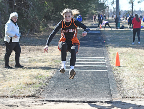 With Coach Nancy Lockmon looking on as the triple jump event coordinator, Giltner freshman Jayci Buettner flies through the air at the Osceola Invite Thursday.